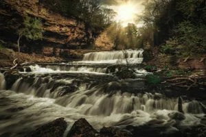 waterfalls surrounded by forest during daytime jigsaw puzzle
