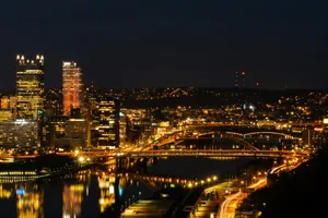 a view of a city at night with a bridge in the foreground jigsaw puzzle