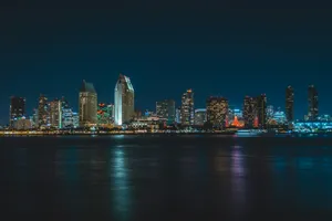 city near body of water during nighttime jigsaw puzzle