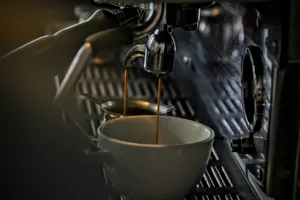 Espresso dripping into a porcelain mug from a steel machine jigsaw puzzle