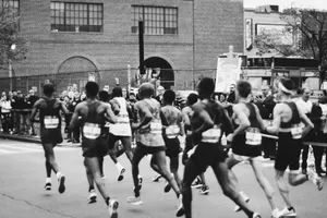 grayscale photo of men running on marathon jigsaw puzzle
