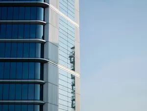 Modern glass building facade against a clear blue sky jigsaw puzzle