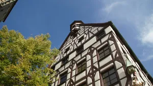 Traditional timber-framed building against blue sky jigsaw puzzle