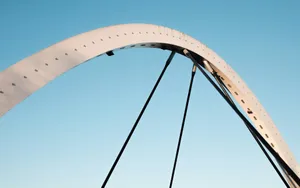 Curved bridge arch against a clear blue sky jigsaw puzzle