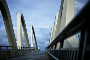 Modern bridge with curved white supports under sky jigsaw puzzle