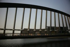 Modern bridge structure over water at dusk jigsaw puzzle