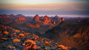 Capture the breathtaking sunset across the rocky terrains of Tamanrasset, Algeria. jigsaw puzzle