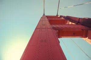 Upward shot of the iconic Golden Gate Bridge tower against a clear sky in San Francisco. jigsaw puzzle