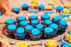 Delicious mini cupcakes with blue frosting on a decorative tray, perfect for celebrations. jigsaw puzzle