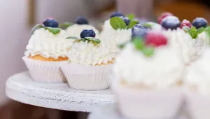 Close-up of cupcakes topped with blueberries, raspberries, and creamy frosting, ideal for dessert and baking themes. jigsaw puzzle