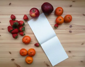 Top view of fresh fruits and an open notepad on a wooden surface, perfect for healthy lifestyle themes. jigsaw puzzle