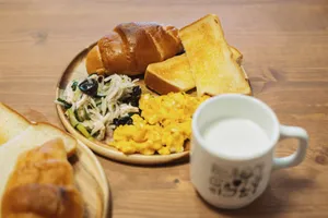 Tasty Japanese breakfast with scrambled eggs, bread, salad, and milk. Captured in Itabashi City, Tokyo. jigsaw puzzle