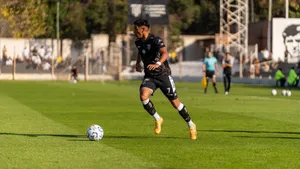 Soccer player dribbling the ball during a daytime match outdoors. jigsaw puzzle