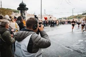 Photographer takes shots at a bustling city marathon event. jigsaw puzzle