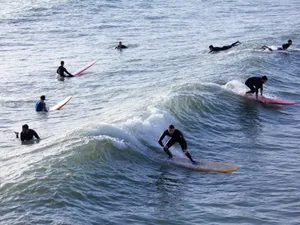 Surfers enjoying ocean waves on a sunny day, capturing the thrill of water sports. jigsaw puzzle