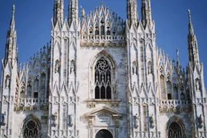 Close-up view of the intricate Gothic facade of Milan Cathedral in Italy against a clear blue sky. jigsaw puzzle