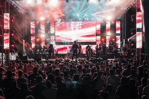 Vibrant outdoor concert event in Santa Marta with a lively crowd and colorful lighting effects. jigsaw puzzle
