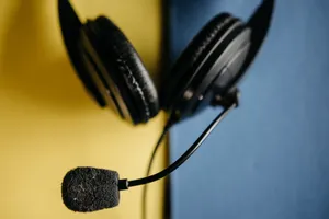 A detailed view of a black headset with microphone on a blue and yellow background, ideal for tech themes. jigsaw puzzle