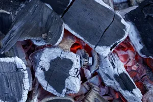 Detailed view of intense glowing charcoal embers with partially burned wood pieces. jigsaw puzzle