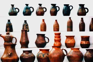 Collection of intricately designed pottery jugs and vases on a white background showcasing traditional craftsmanship. jigsaw puzzle