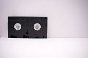 Black VHS tape on a white minimalist background, highlighting retro technology. jigsaw puzzle