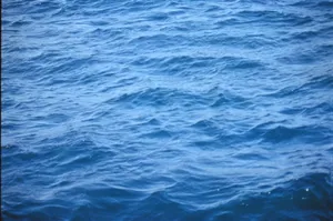 Serene view of blue ocean waves gently rippling under daylight. jigsaw puzzle