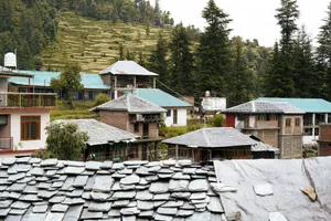 a group of houses sitting on top of a lush green hillside jigsaw puzzle