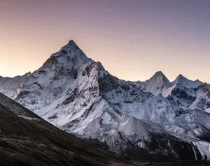 a mountain range covered in snow at sunset jigsaw puzzle