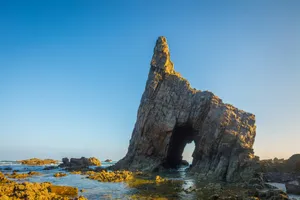 a large rock sticking out of the ocean jigsaw puzzle