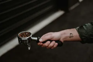 person holding silver and black coffee pot jigsaw puzzle