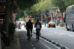 Two cyclists ride on a city street. jigsaw puzzle