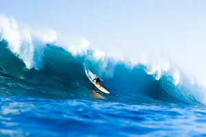 Surfer riding a massive wave at sea jigsaw puzzle