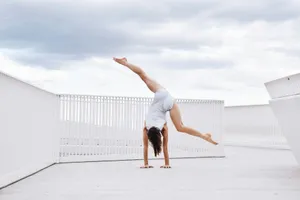 a woman is doing a handstand on the ground jigsaw puzzle