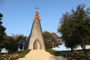 A very tall steeple with a cross on top of it jigsaw puzzle