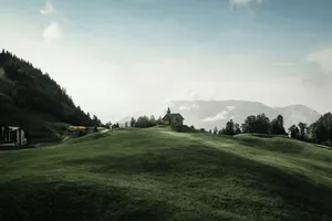 A green hill with a small church. jigsaw puzzle