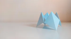 green paper boat on white table jigsaw puzzle