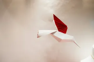 a red origami bird flying in the sky jigsaw puzzle