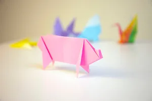pink origami in front of other color origamis jigsaw puzzle