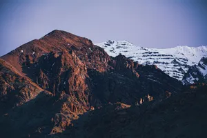 Stunning view of the Himalayas with rocky peaks and snow, captured at sunrise with vibrant colors. jigsaw puzzle