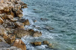 Waves crashing on a rocky shoreline, showcasing nature's beauty and motion. jigsaw puzzle