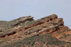 Stunning red sandstone rock formations showcasing unique geological structures against a clear sky. jigsaw puzzle