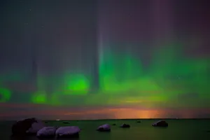 Capture of vivid Northern Lights reflecting over the serene Estonian coastline. jigsaw puzzle