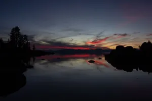 Captivating sunset view over a peaceful lake with vibrant sky reflections captured during twilight. jigsaw puzzle