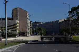 A clear day cityscape featuring an empty road and distinctive buildings. jigsaw puzzle