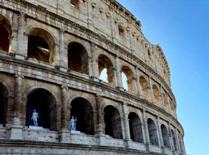 Side view of Rome's iconic Colosseum with clear blue sky. jigsaw puzzle