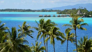 Scenic tropical seascape with palm trees and overwater bungalows. jigsaw puzzle