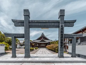Peaceful view of a traditional Japanese temple entrance with a Torii gate. jigsaw puzzle