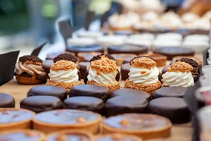 A delectable array of gourmet pastries and desserts featuring creamy, chocolate, and nut toppings, perfect for indulgence. jigsaw puzzle