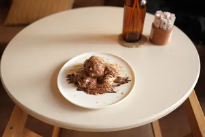 Delicious cream puffs drizzled with chocolate sauce, perfect dessert setting. jigsaw puzzle