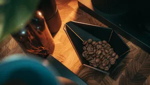 Top view of coffee beans in a modern geometric bowl with a warm ambiance, perfect for cafes. jigsaw puzzle
